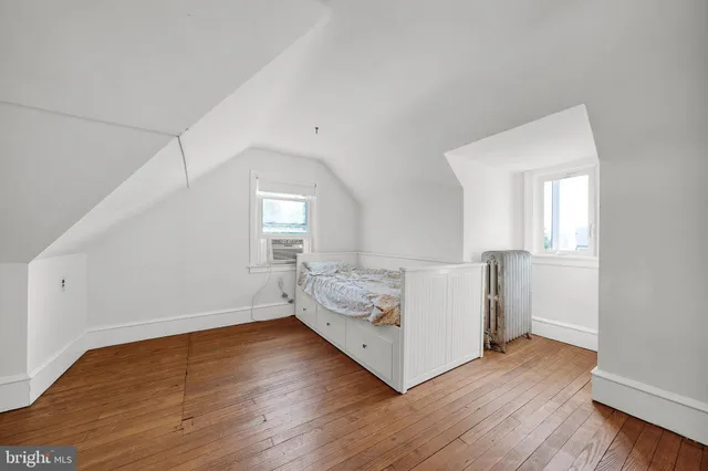 a view of a room with wooden floor and window
