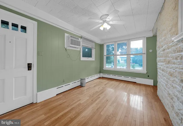 wooden floor in an empty room with a window