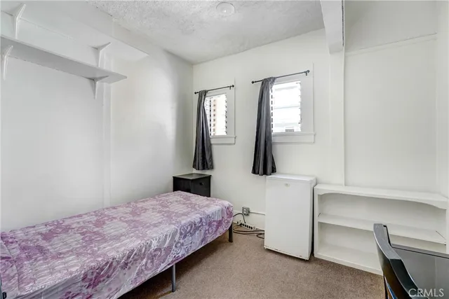 a bedroom with furniture and a window