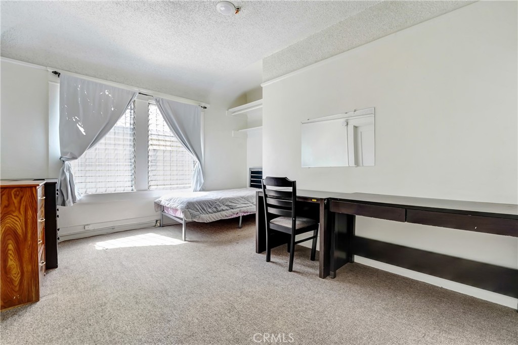 1041 Elden Avenue Los Angeles, CA 90006 - Photo 12 of 25 a bedroom with furniture and a window