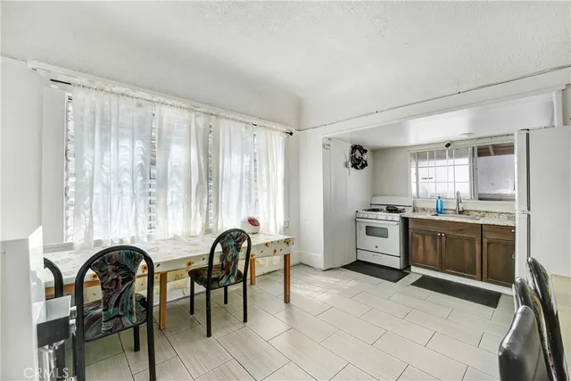 a kitchen with a stove and white cabinets