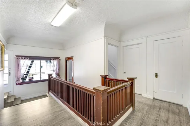 a bedroom with a bed a mirror and window