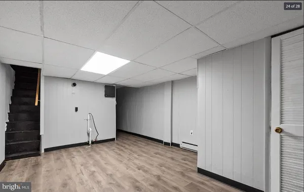a view of a livingroom with an empty space and wooden floor