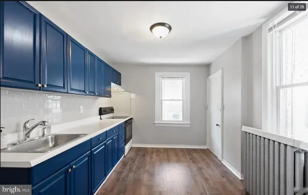 a kitchen with granite countertop wooden cabinets a sink and dishwasher