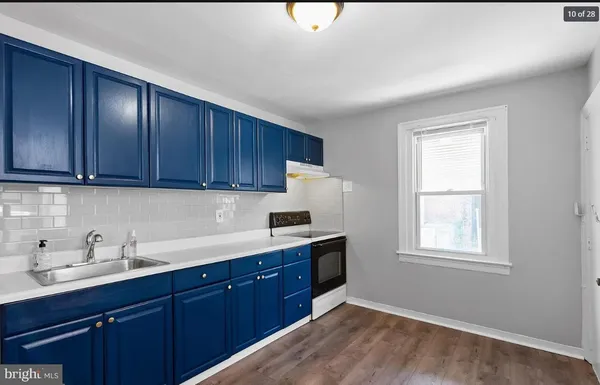 a kitchen with a sink cabinets and window