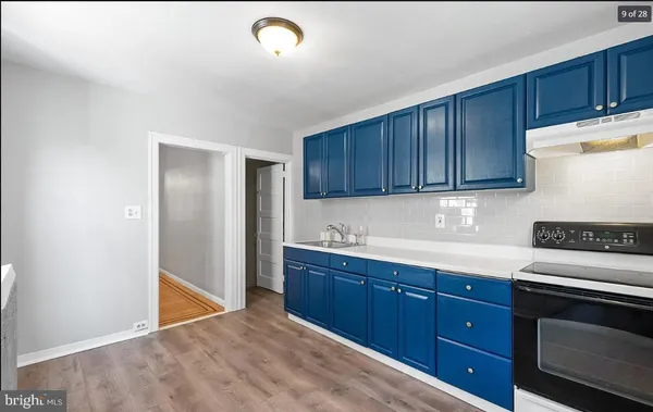 a kitchen with wood cabinets and white appliances