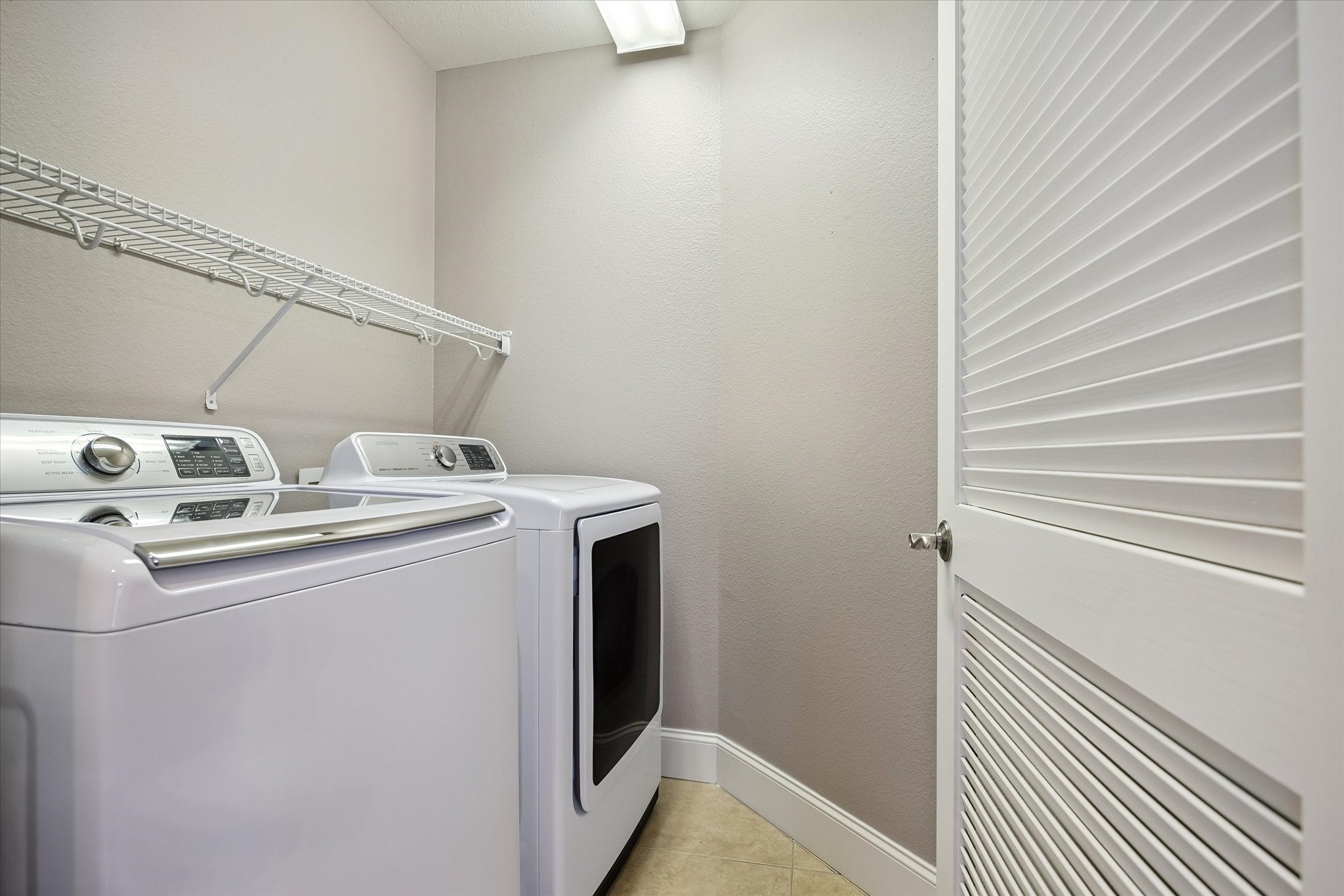 2120 Kipling Street, Unit 304 Houston, TX 77098 - Photo 21 of 24 An in-unit laundry area adds everyday convenience while complementing the home’s move-in ready functionality and efficient layout.
