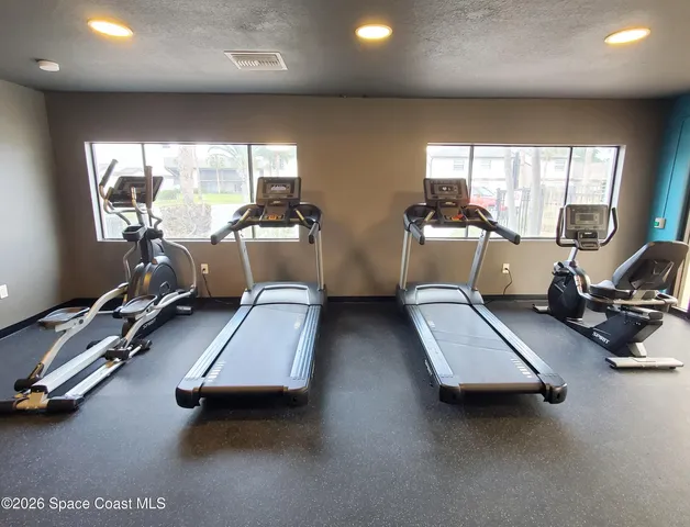 a room with gym equipment and a large window