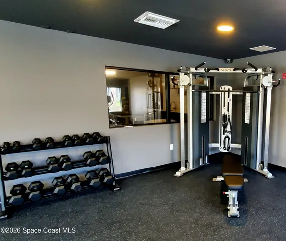 a gym room with lots of gym equipment