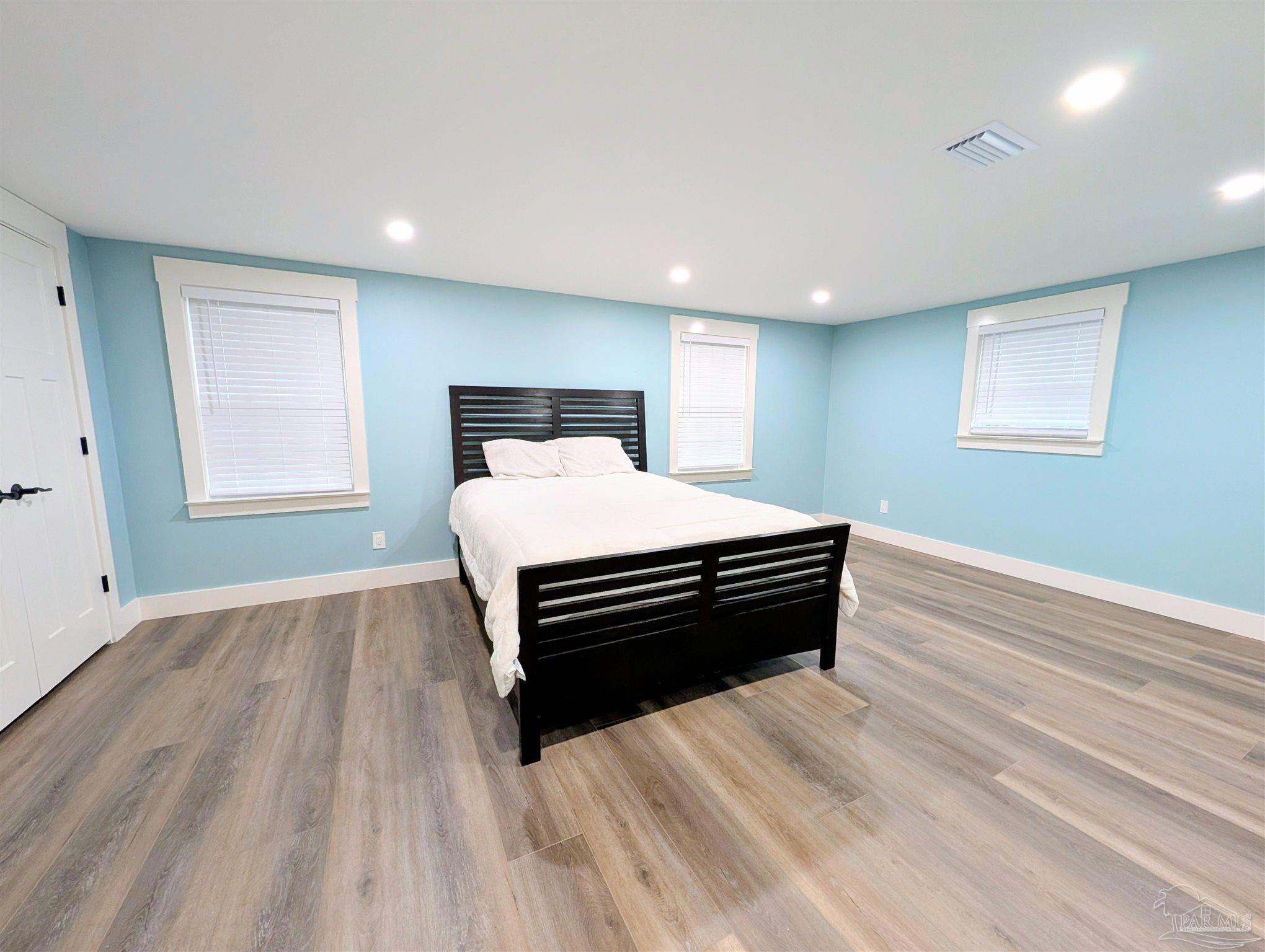 222 Santa Rosa Road Cantonment, FL 32533 - Photo 13 of 48 a bedroom with a bed and wooden floor