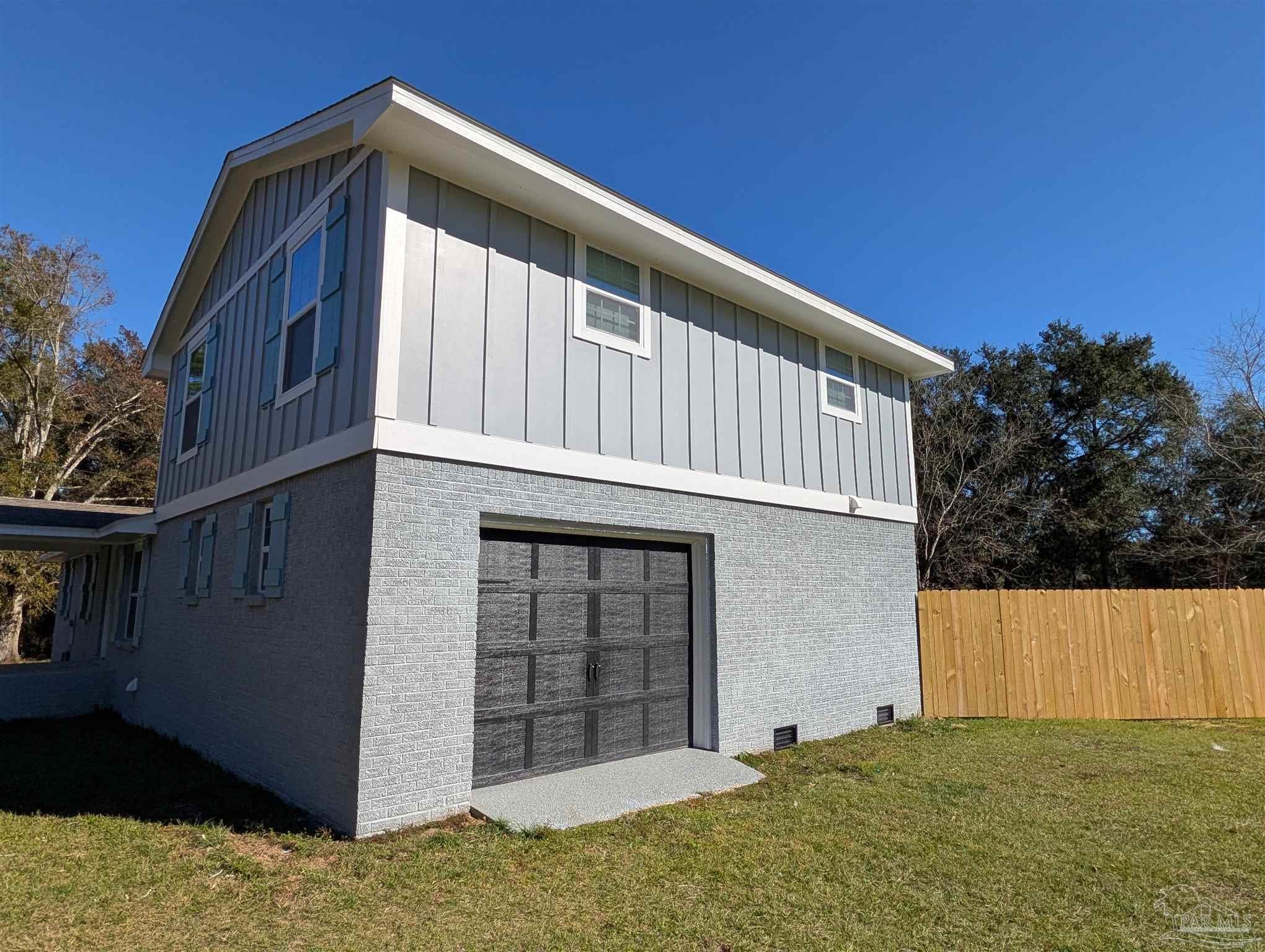 222 Santa Rosa Road Cantonment, FL 32533 - Photo 2 of 48 a front view of a house with a yard