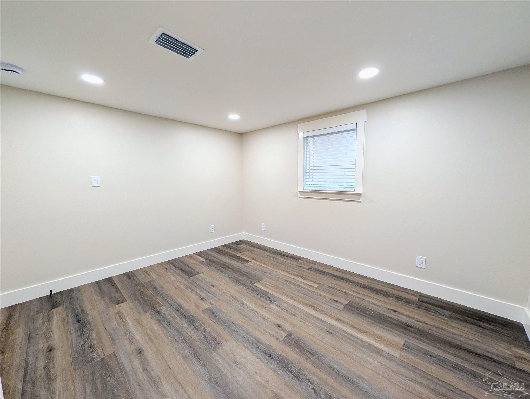 222 Santa Rosa Road Cantonment, FL 32533 - Photo 23 of 48 a view of empty room with wooden floor