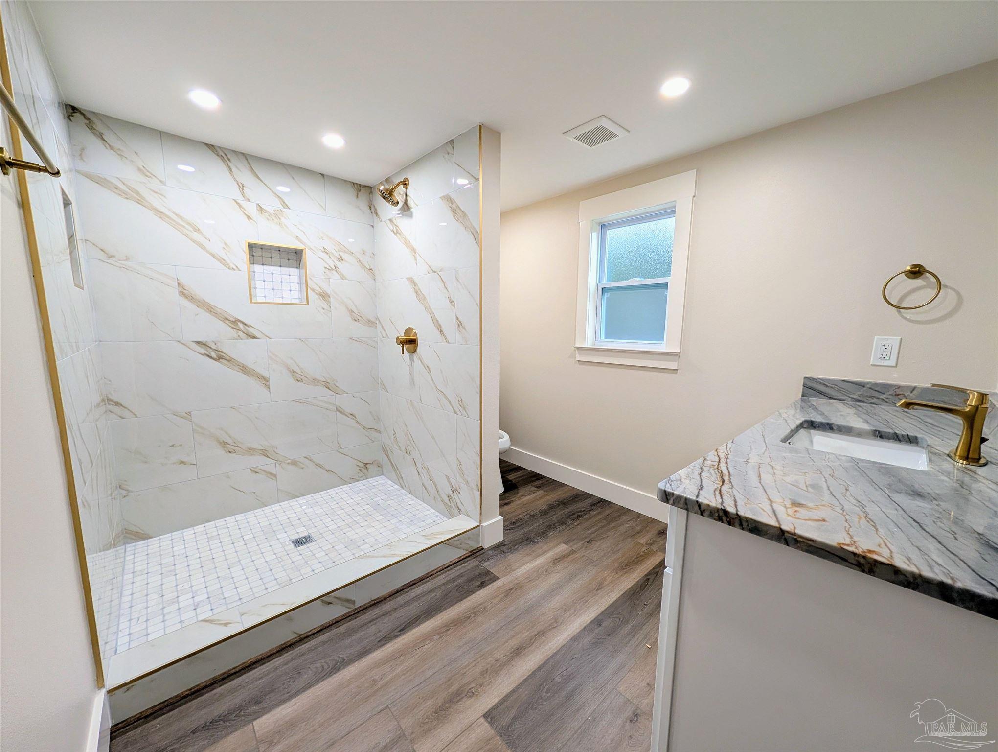 222 Santa Rosa Road Cantonment, FL 32533 - Photo 24 of 48 a bathroom with a granite countertop sink a mirror and shower