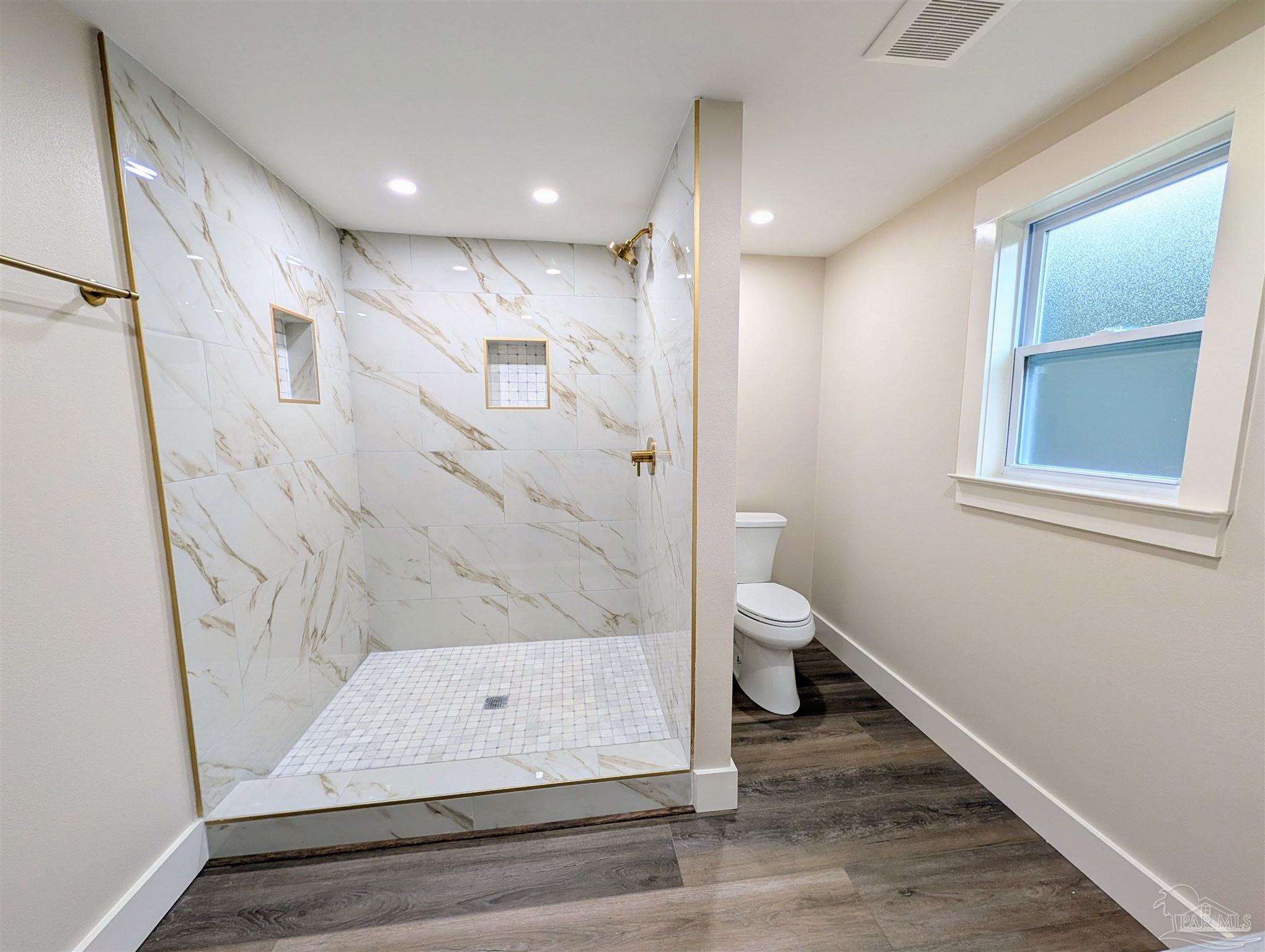 222 Santa Rosa Road Cantonment, FL 32533 - Photo 27 of 48 a bathroom with a shower and a toilet