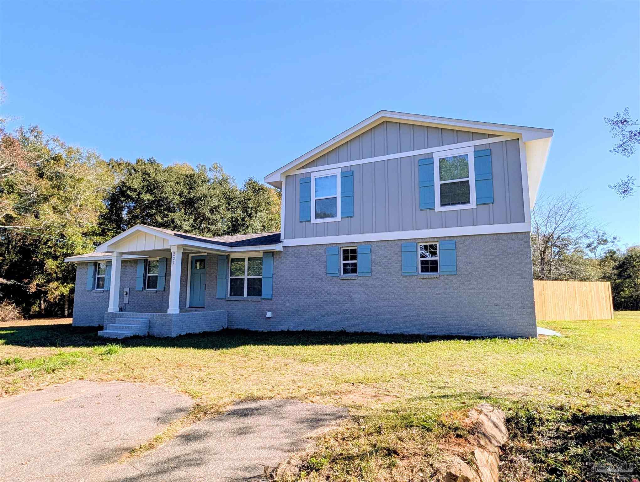 222 Santa Rosa Road Cantonment, FL 32533 - Photo 36 of 48 a view of a house with a yard