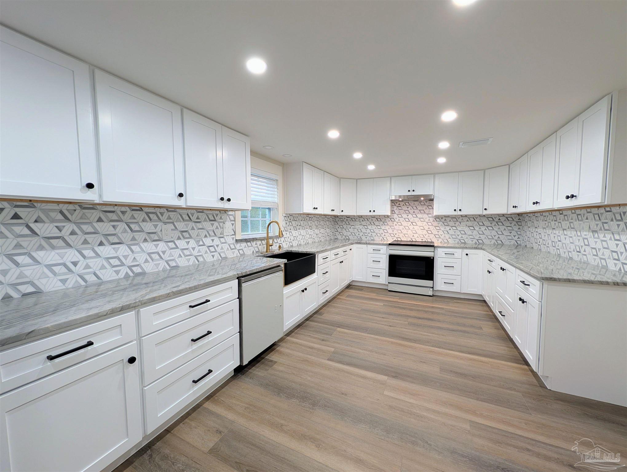 222 Santa Rosa Road Cantonment, FL 32533 - Photo 4 of 48 a kitchen with granite countertop white cabinets and white appliances