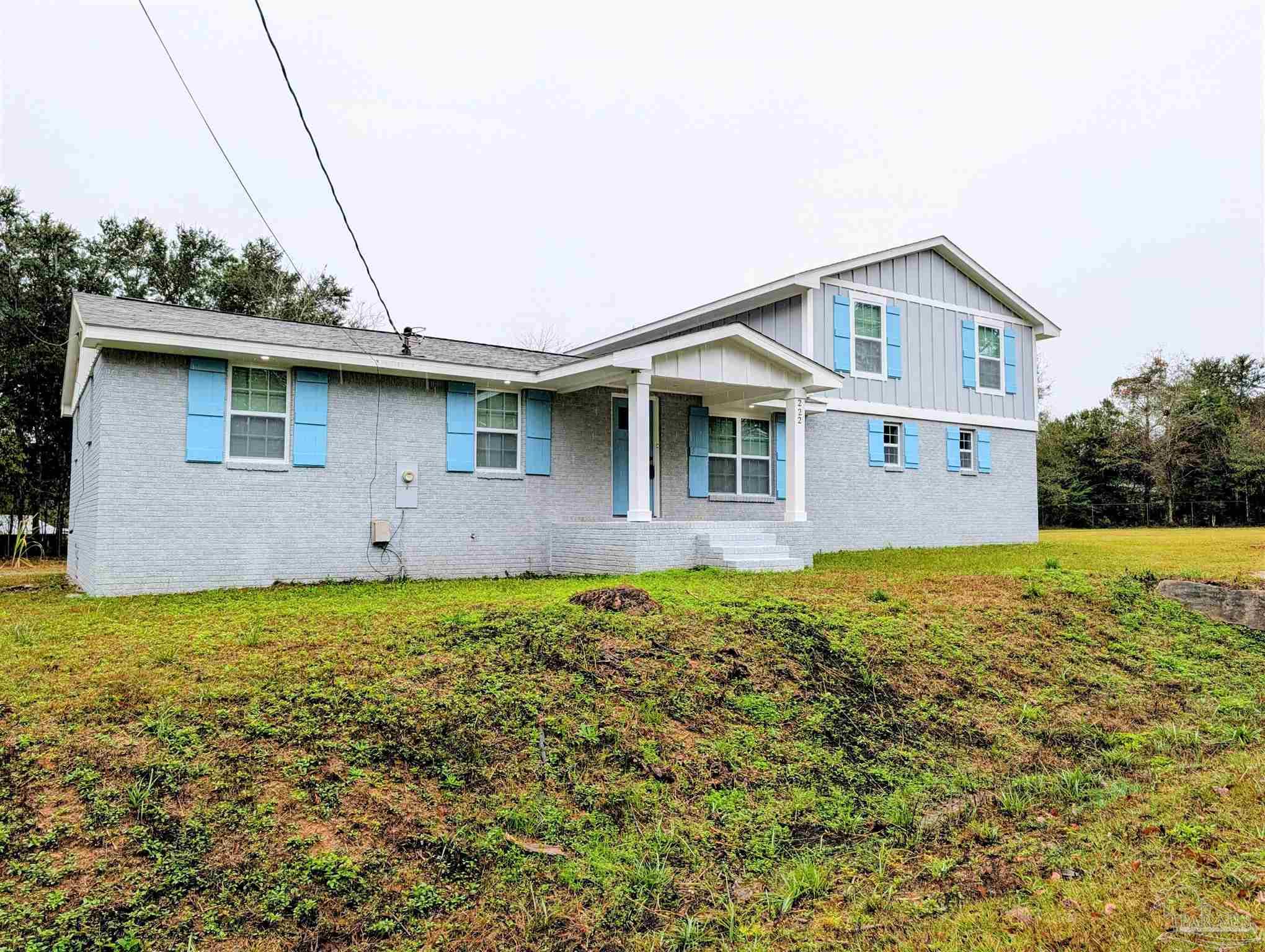 222 Santa Rosa Road Cantonment, FL 32533 - Photo 48 of 48 a front view of a house with garden