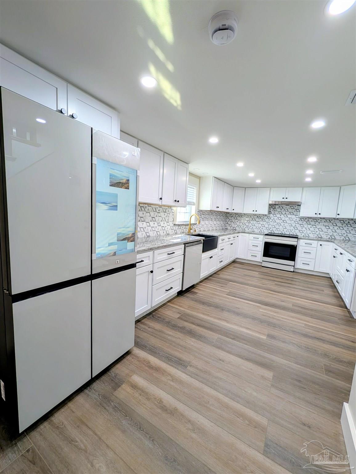 222 Santa Rosa Road Cantonment, FL 32533 - Photo 8 of 48 a kitchen with stainless steel appliances kitchen island granite countertop a refrigerator a stove and a sink