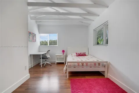 a bedroom with a bed and a workspace