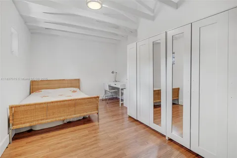 a bedroom with a bed and a rug