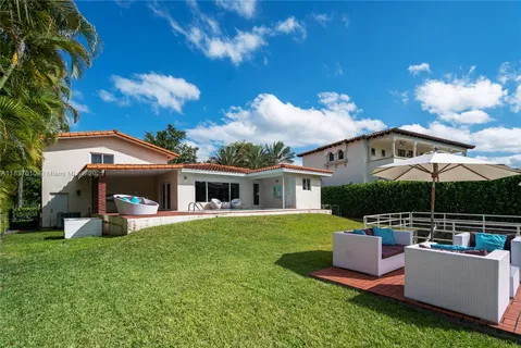 a view of a house with a yard porch and sitting area