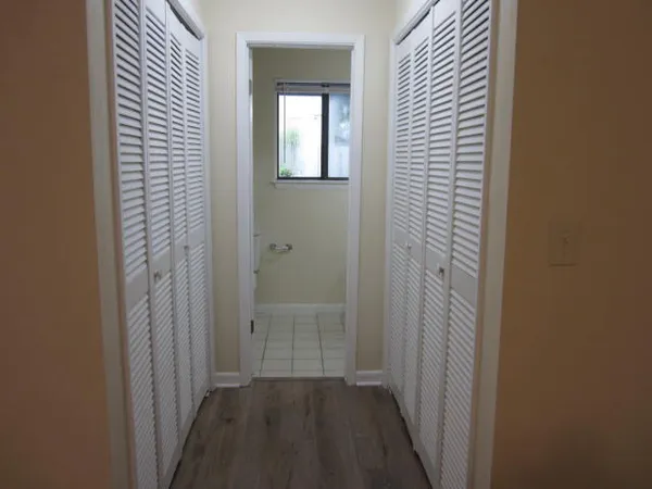 a view of a room with wooden floor and windows