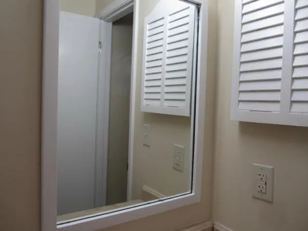 an empty room with wooden floor and closet