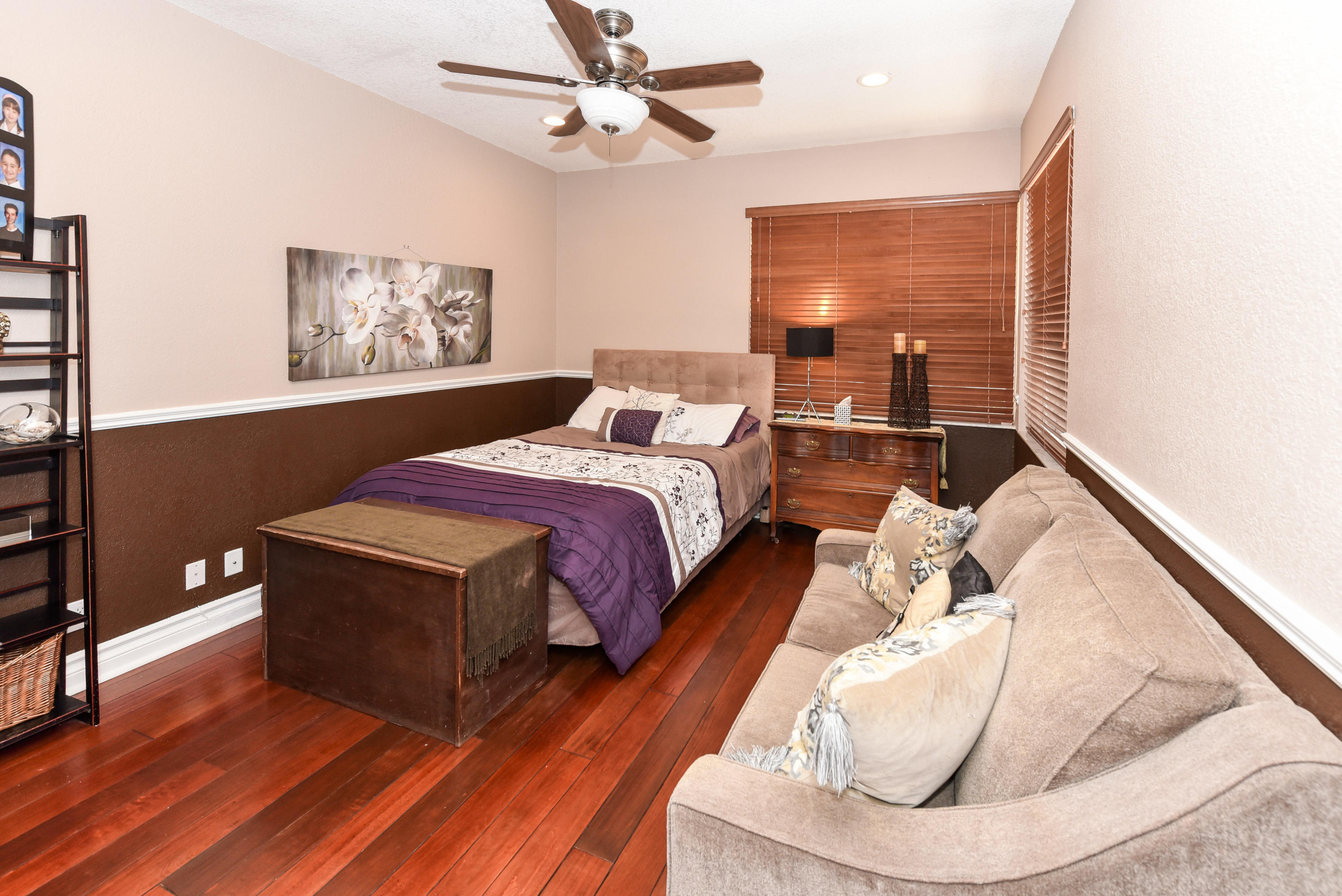 5855 Paddington Way Boca Raton, FL 33496 - Photo 25 of 40 a living room with a bed furniture and a large window