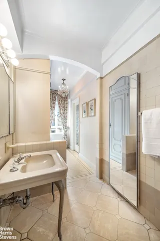 a spacious bedroom with a bed a couch and dresser