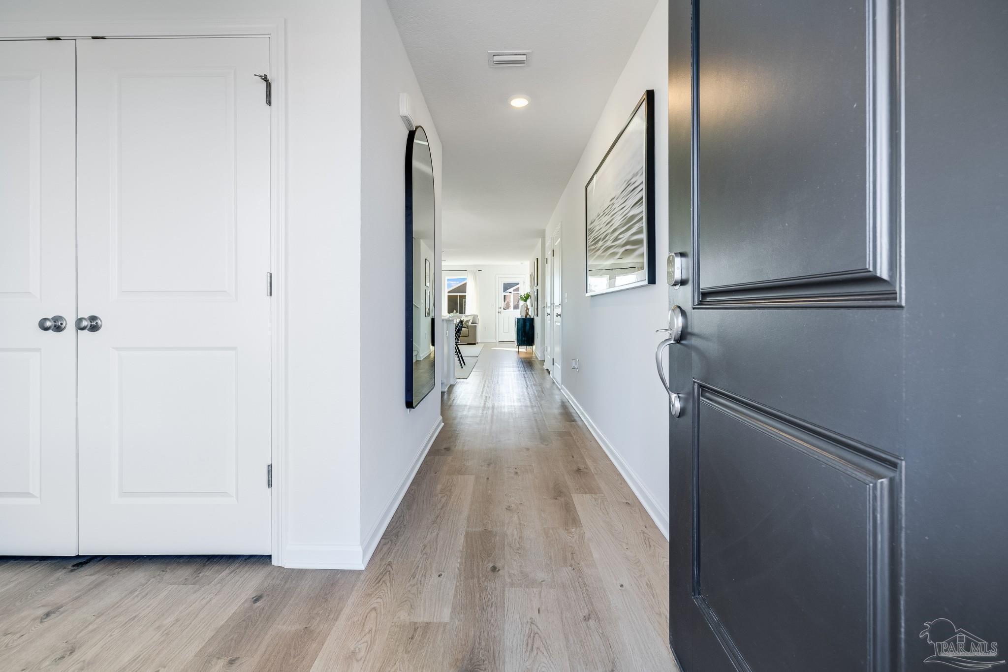5380 Azimuth Way Milton, FL 32583 - Photo 7 of 53 a view of a hallway with wooden floor