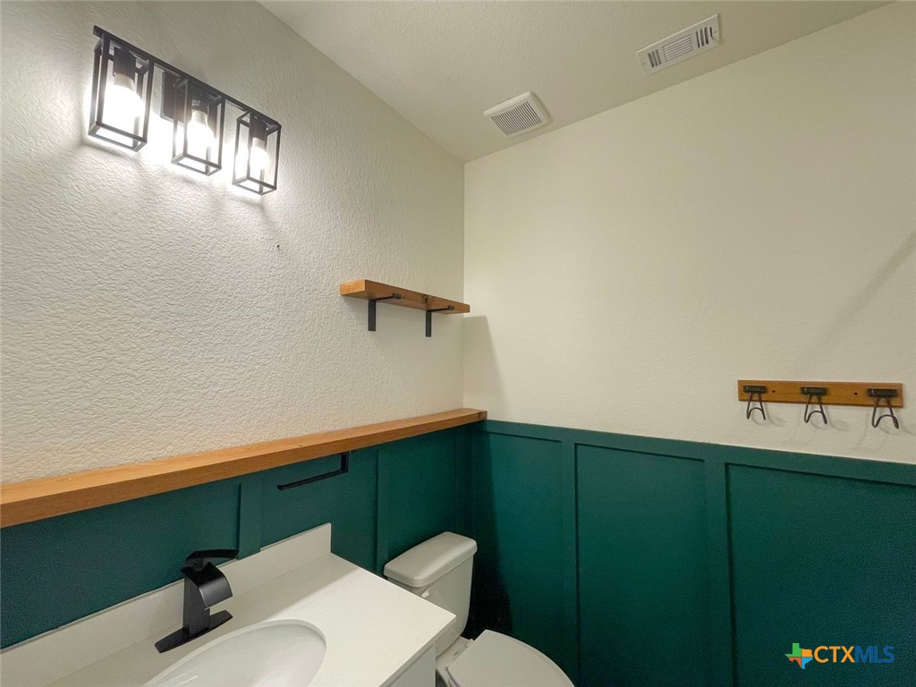 108 Old Stagecoach Road Jarrell, TX 76537 - Photo 15 of 45 a bathroom with a sink mirror vanity and toilet