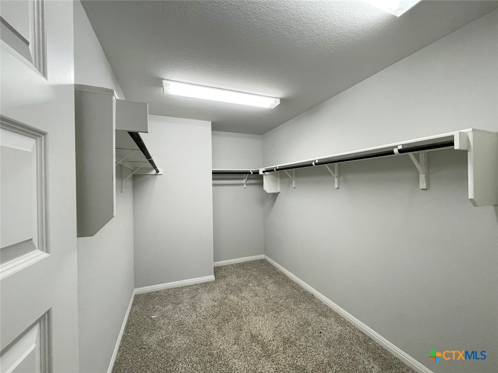 108 Old Stagecoach Road Jarrell, TX 76537 - Photo 22 of 45 a view of walk in closet with empty racks