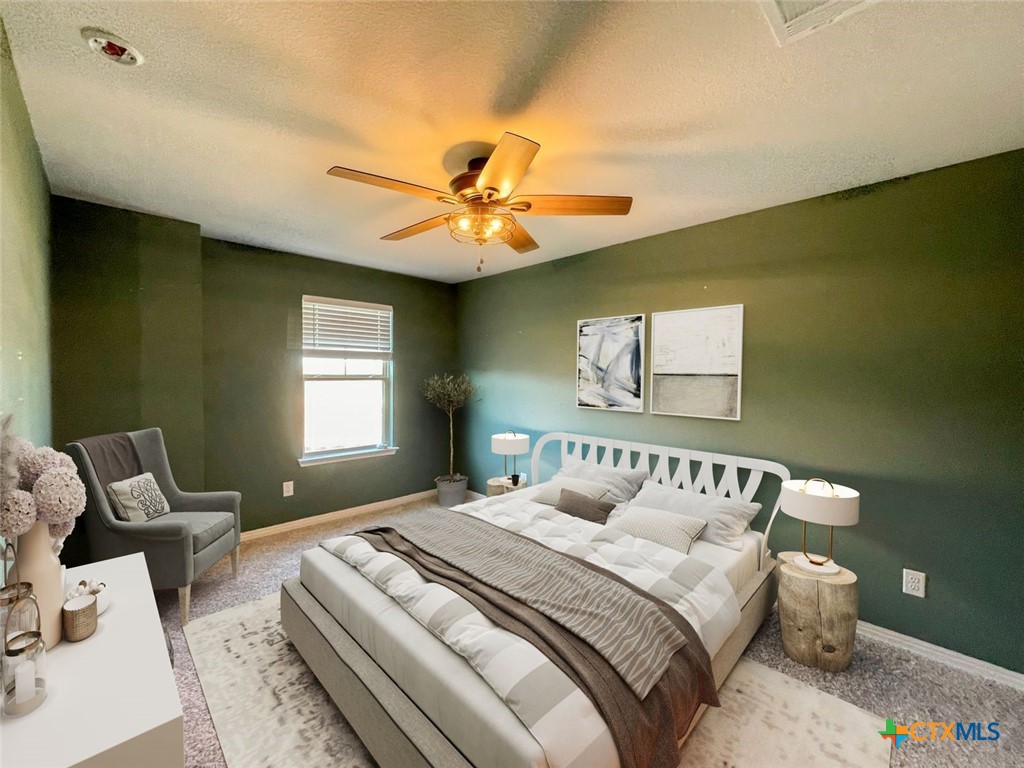 108 Old Stagecoach Road Jarrell, TX 76537 - Photo 27 of 45 a bedroom with a bed and a chandelier