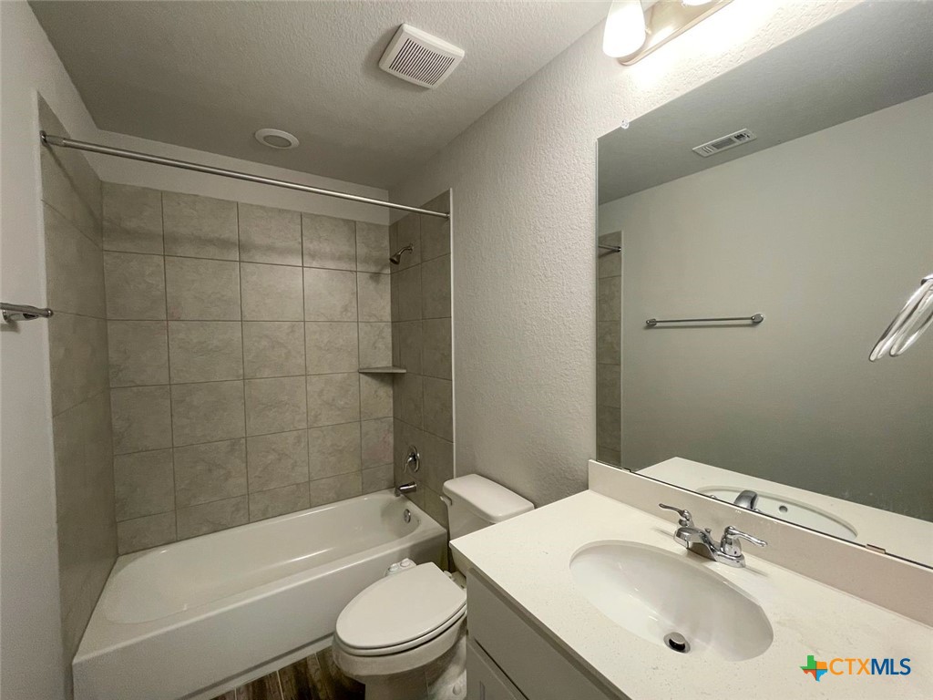 108 Old Stagecoach Road Jarrell, TX 76537 - Photo 28 of 45 a bathroom with a sink mirror toilet and bathtub