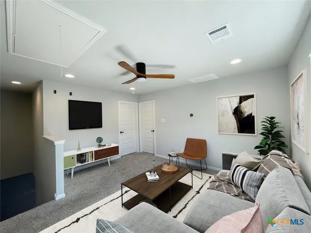 an empty room with a window and ceiling fan