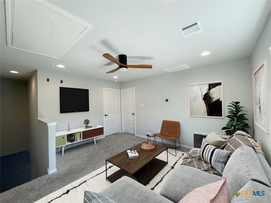 108 Old Stagecoach Road Jarrell, TX 76537 - Photo 30 of 45 a living room with furniture and a flat screen tv