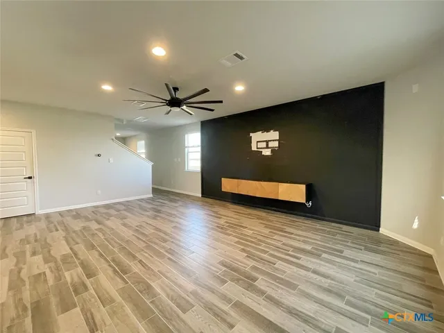 a view of a room with wooden floor