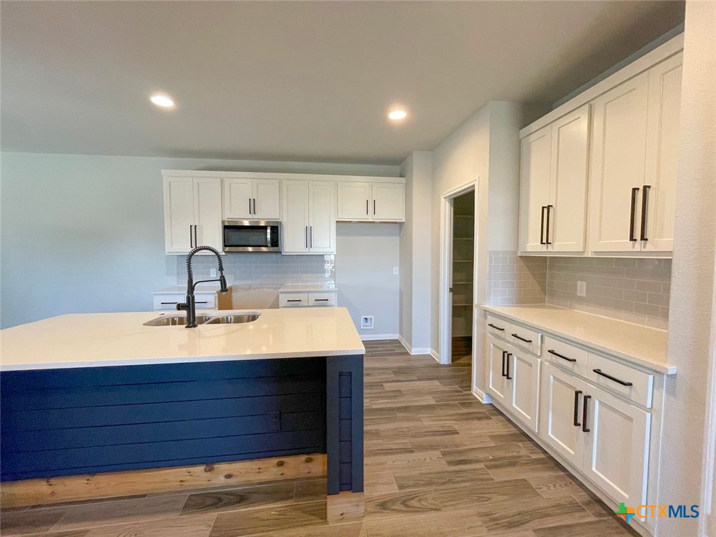 108 Old Stagecoach Road Jarrell, TX 76537 - Photo 6 of 45 a kitchen with stainless steel appliances sink stove refrigerator and cabinets