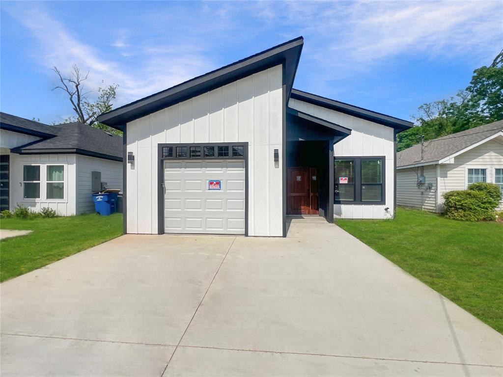 4006 Coolidge Street Dallas, TX 75215 - Photo 1 of 27 a front view of a house with a yard and garage