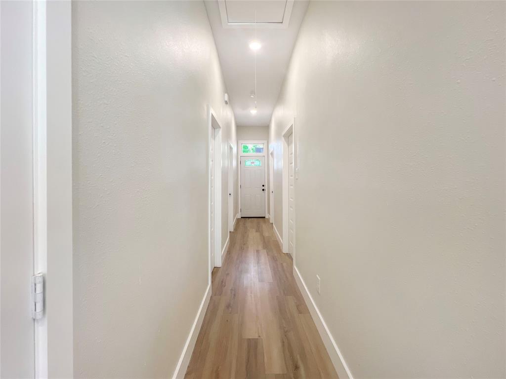 4006 Coolidge Street Dallas, TX 75215 - Photo 11 of 27 a view of a hallway with wooden floor