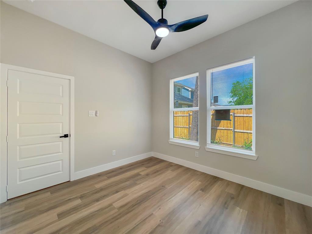 4006 Coolidge Street Dallas, TX 75215 - Photo 15 of 27 a view of an empty room with wooden floor and a window