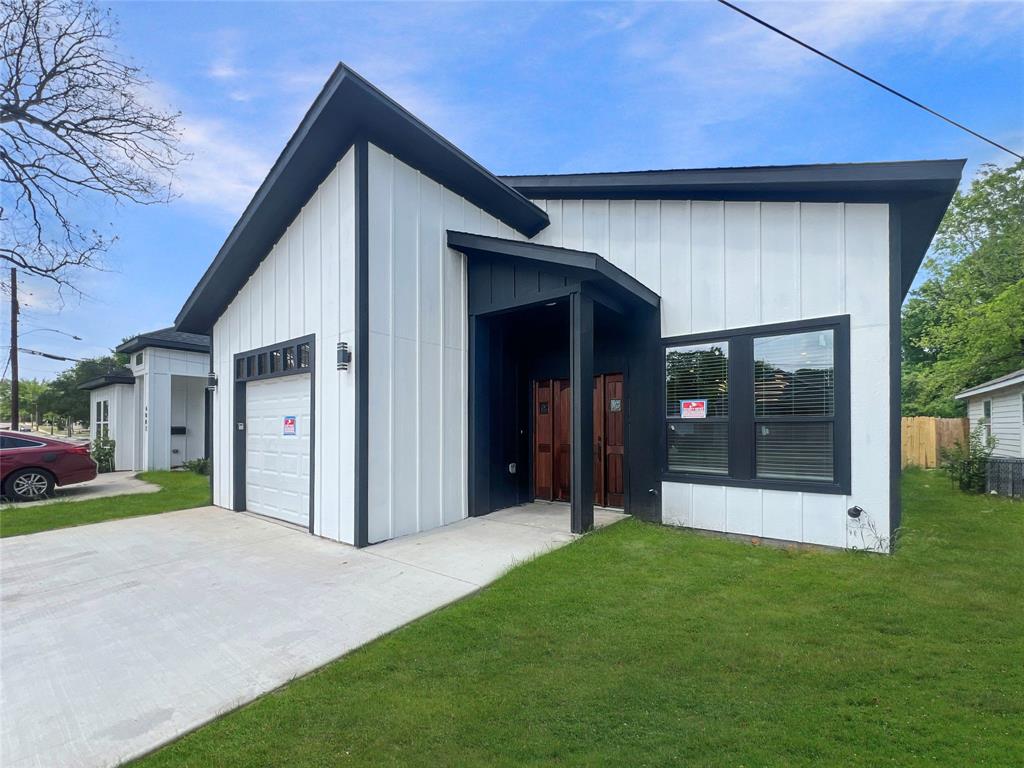 4006 Coolidge Street Dallas, TX 75215 - Photo 2 of 27 a view of a house with a yard and garage
