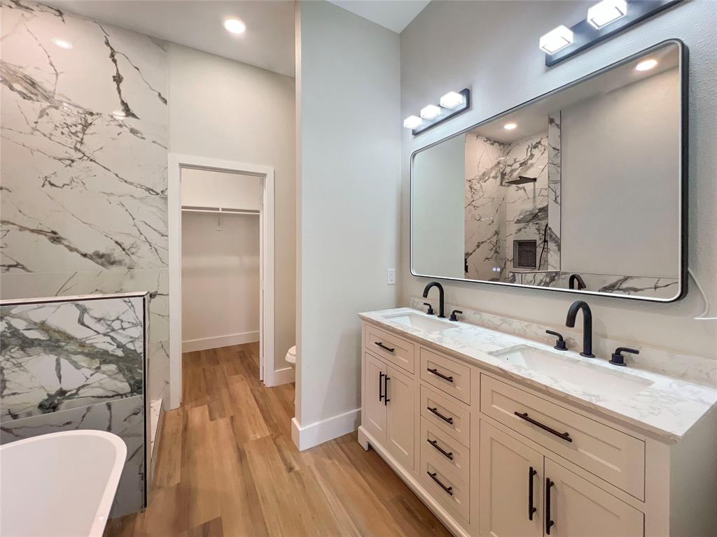 4006 Coolidge Street Dallas, TX 75215 - Photo 21 of 27 a bathroom with a double vanity sink mirror and shower