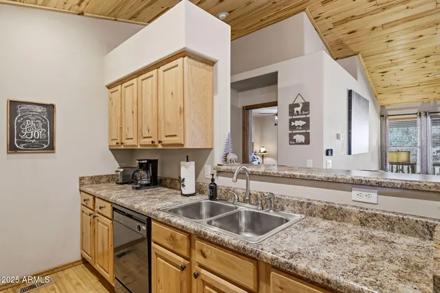 a kitchen with granite countertop a stove and a sink