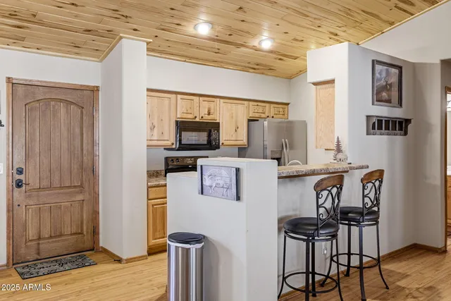 a kitchen with granite countertop a stove and a microwave