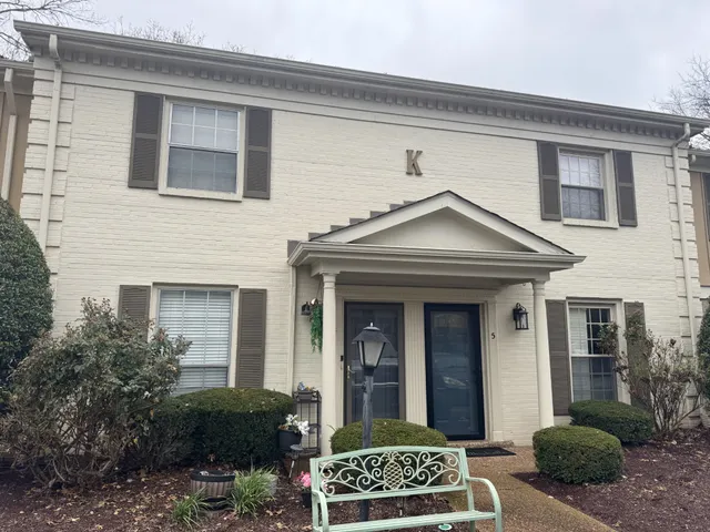 a view of a house with a small yard and plants