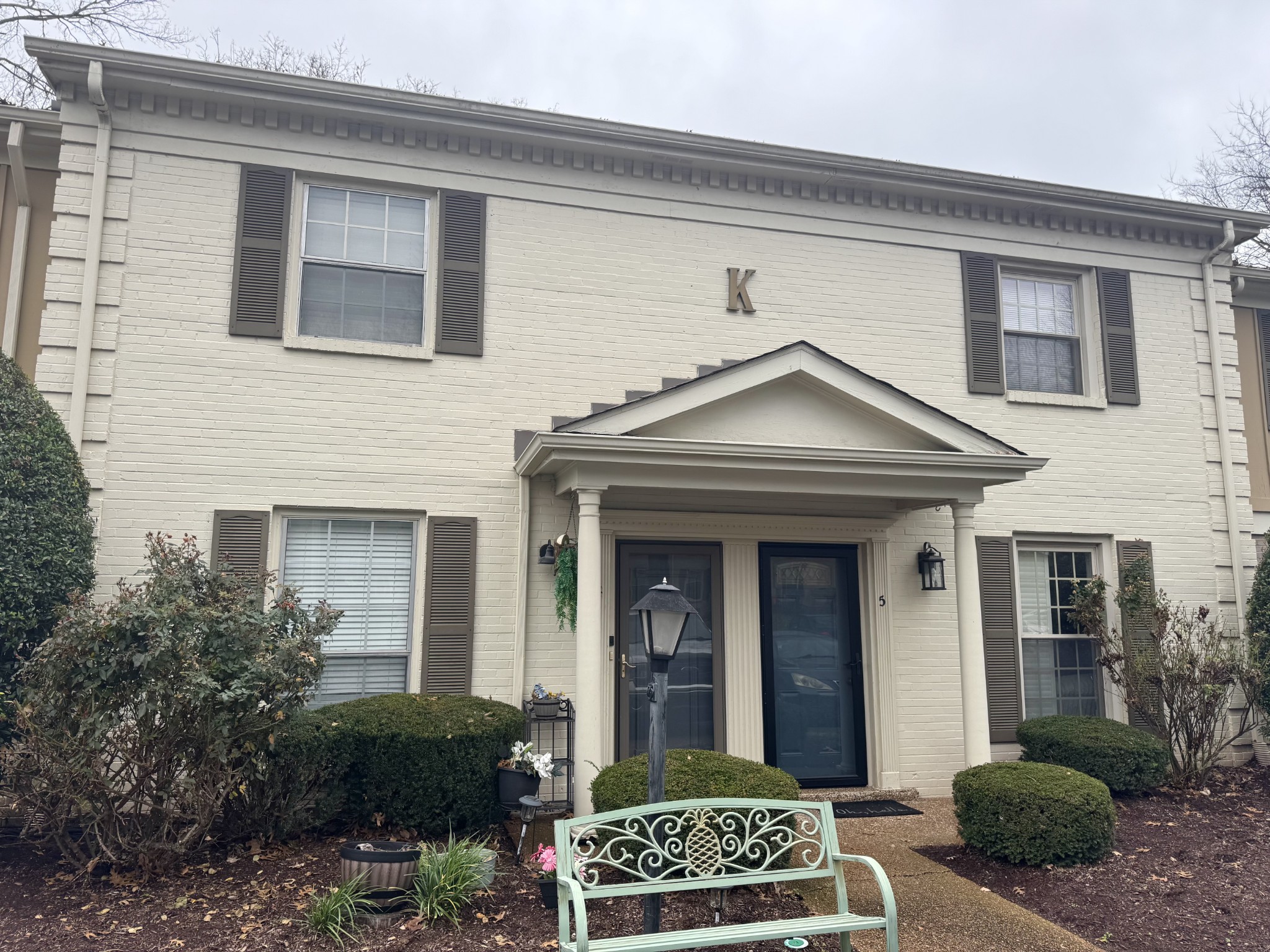 a view of a house with a small yard and plants
