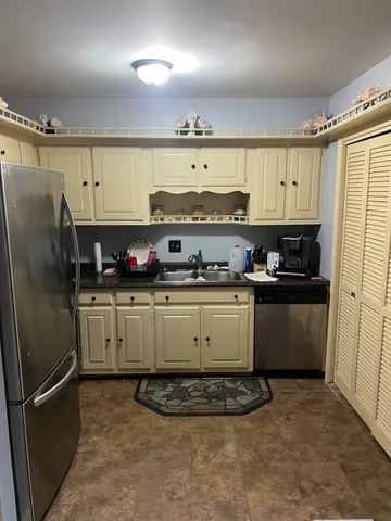 a kitchen with stainless steel appliances granite countertop a refrigerator sink and cabinets