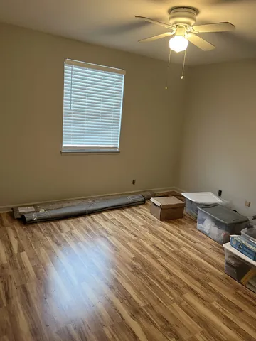 a room with a wooden floor and a window