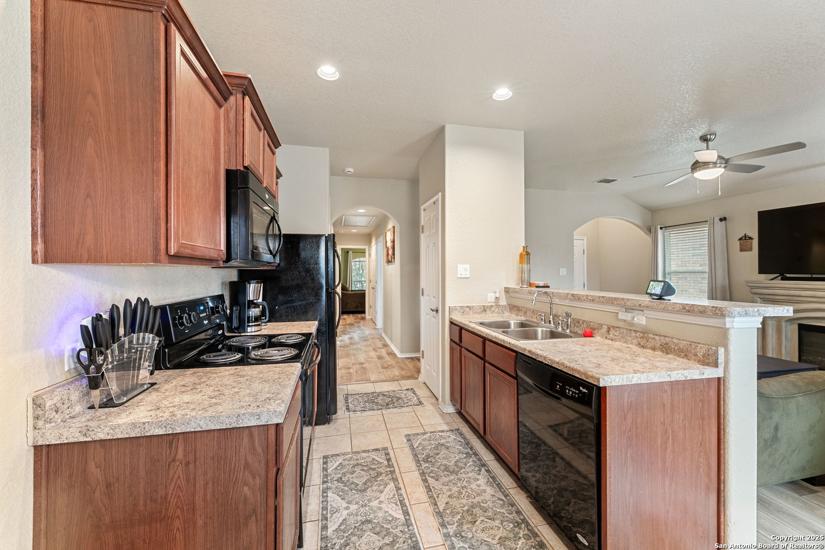 3850 Key W Way Converse, TX 78109 - Photo 11 of 24 a kitchen with granite countertop a sink a counter top space stove and cabinets
